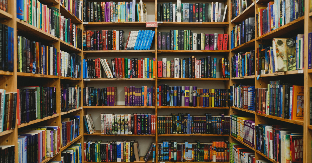 Books on library shelf. Photo by Caleb Woods on Unsplash